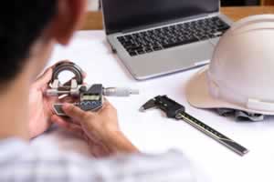 Engineer man hand measuring bearing with digimatic micrometer