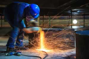 Male worker wearing protective clothing and repair grinding fabrication